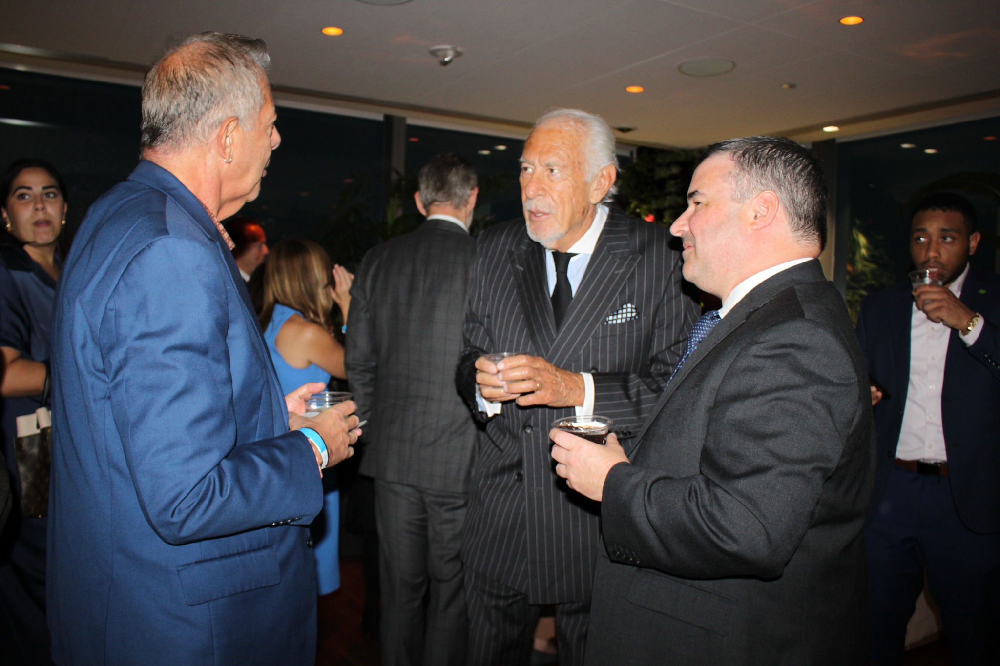 Three men having discussion NADAP Anniversary Reception, 2023