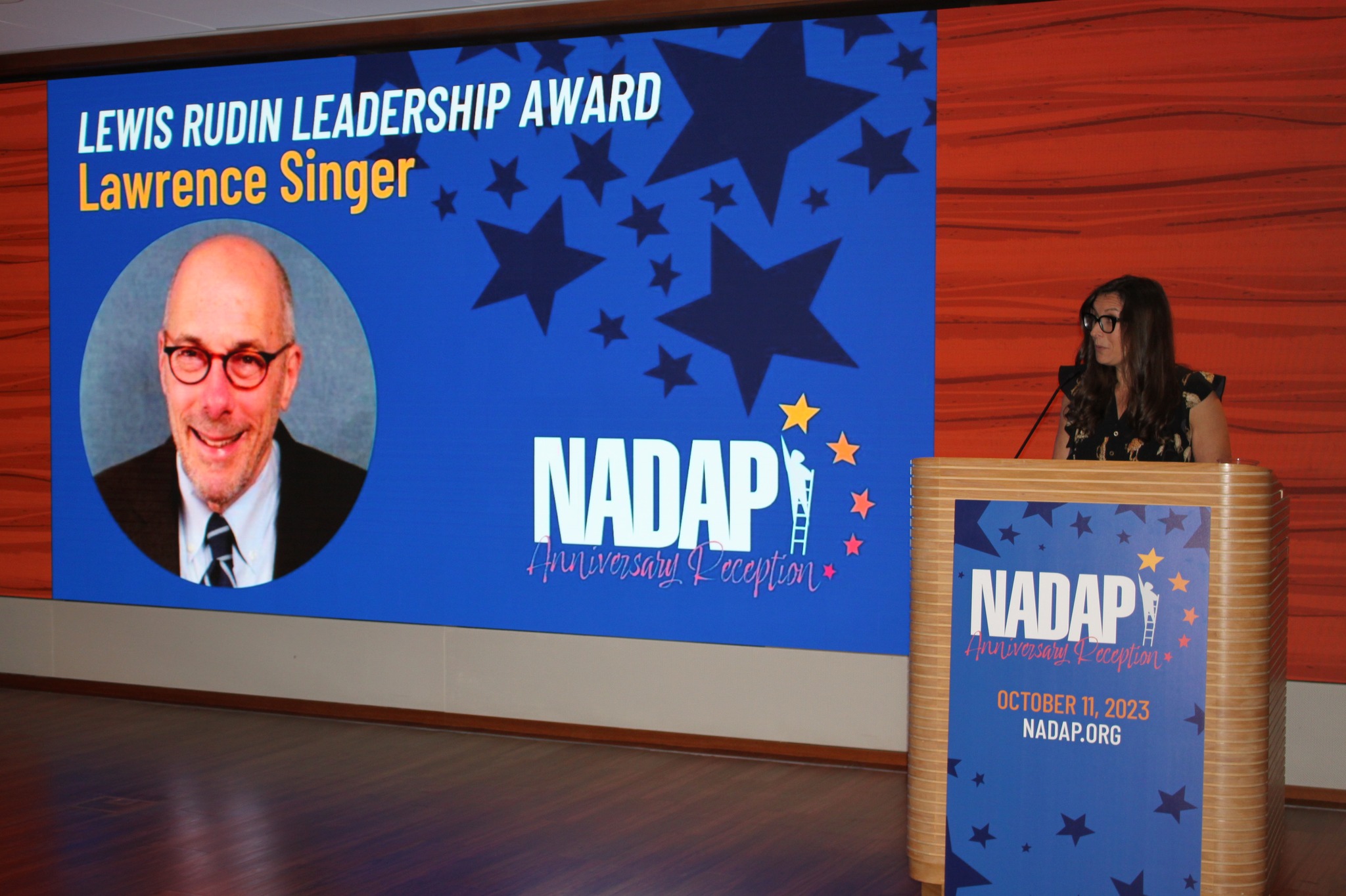Woman presenting at podium NADAP Anniversary Reception, 2023