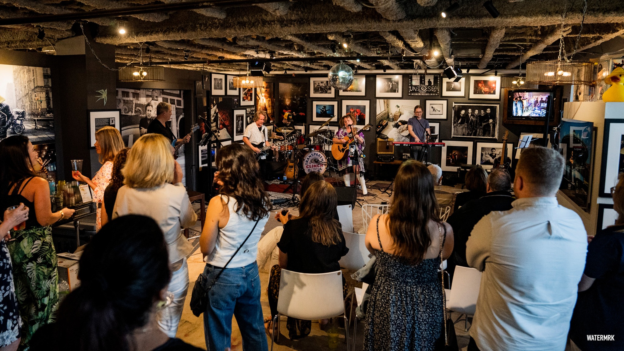 Band performing in front of audience on stage Sunset Jam, 2023